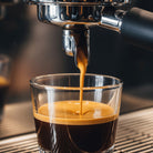 Espresso being poured from a machine into a glass uaing JustFreshRoasted Supa Crema blend.